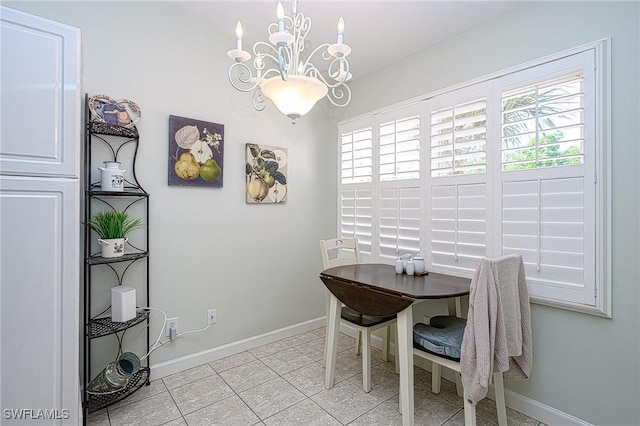 dining space with light tile patterned floors and a chandelier