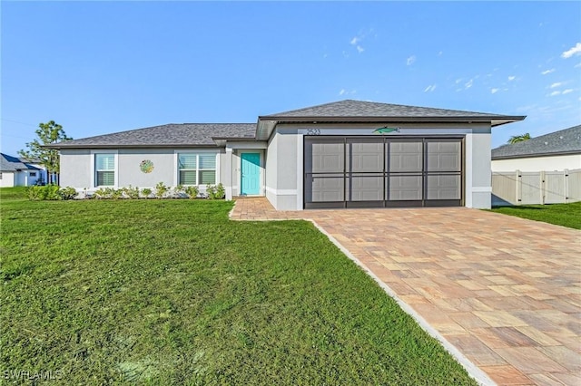 view of front of home featuring a garage and a front lawn