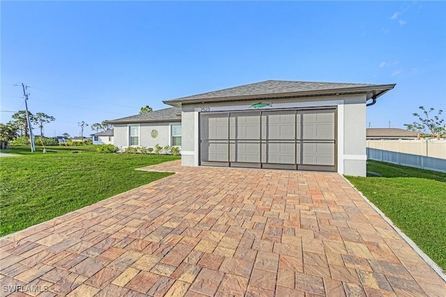 view of front facade with a garage and a front lawn