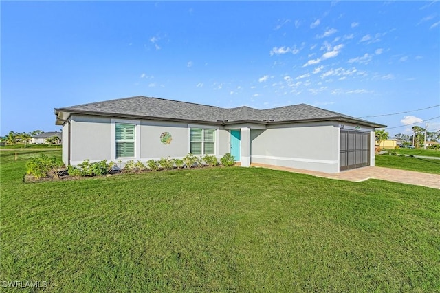 view of front of home with a garage and a front yard