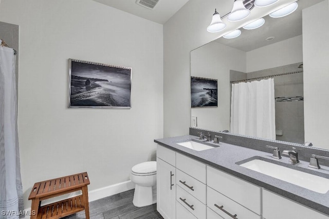 bathroom with vanity, hardwood / wood-style floors, toilet, and walk in shower