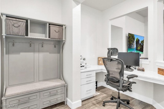 office space with hardwood / wood-style flooring and built in desk