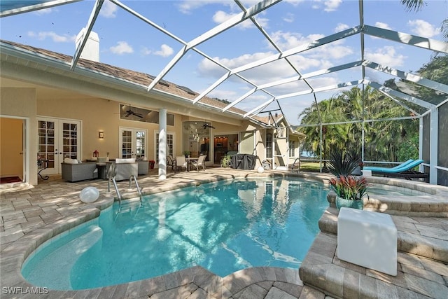 view of swimming pool featuring a lanai, ceiling fan, a patio area, french doors, and an in ground hot tub