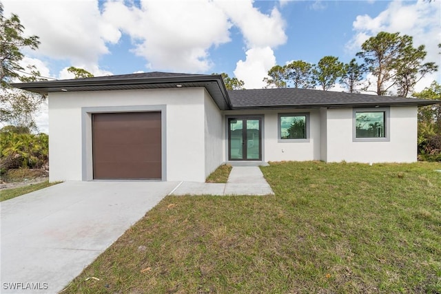 view of front of house with a garage and a front yard