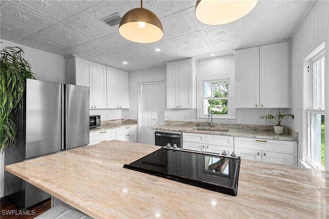 3475 Edgewood Ave, Fort Myers, FL 33916 - kitchen with pendant lighting, sink, black appliances, light stone countertops, and white cabinets