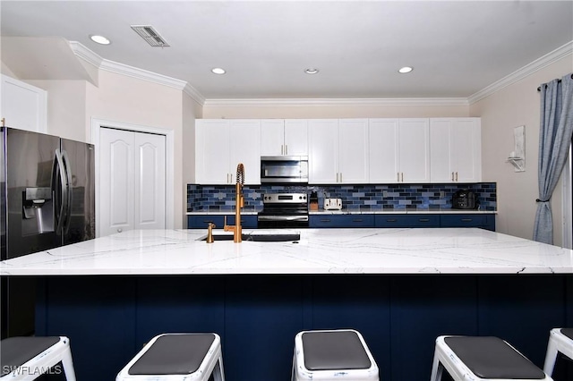 kitchen with light stone counters, stainless steel appliances, a breakfast bar, and a large island with sink