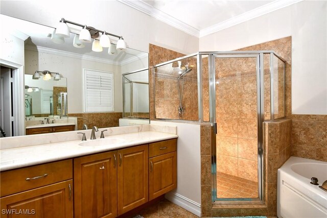 bathroom with crown molding, vanity, and separate shower and tub