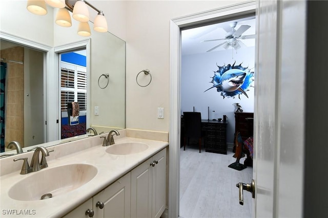 bathroom with vanity, hardwood / wood-style floors, and ceiling fan