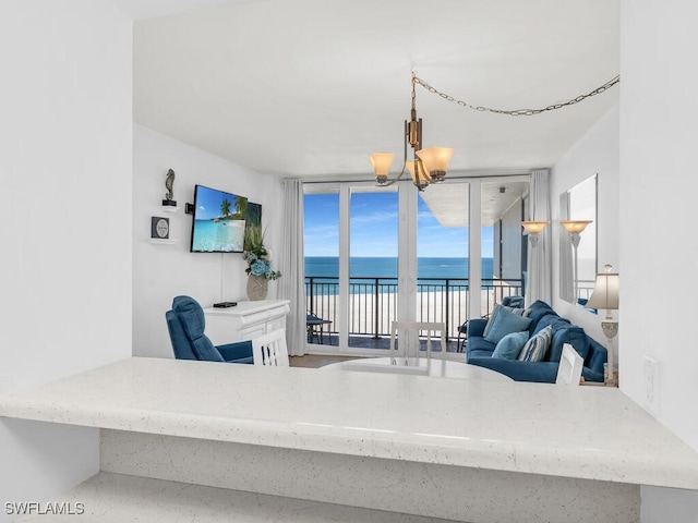 living room featuring expansive windows and a notable chandelier