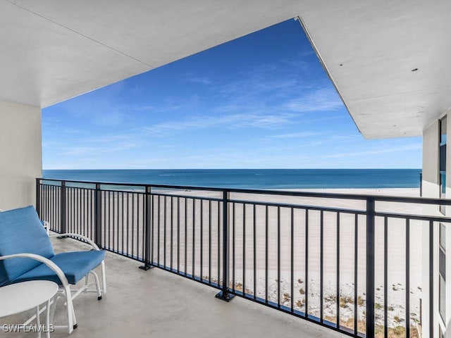 balcony with a view of the beach and a water view