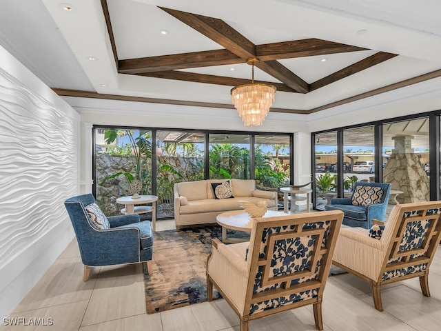 living room with beamed ceiling, coffered ceiling, a healthy amount of sunlight, and an inviting chandelier