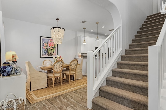 dining area with a notable chandelier and light hardwood / wood-style floors