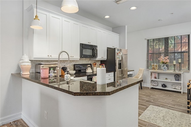 kitchen with white cabinetry, pendant lighting, black appliances, and kitchen peninsula