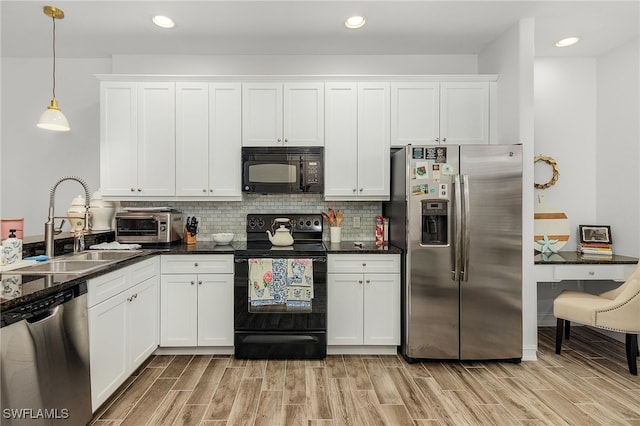 kitchen with decorative light fixtures, sink, white cabinets, decorative backsplash, and black appliances