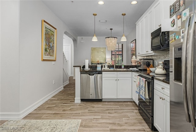 kitchen featuring black appliances, white cabinetry, decorative backsplash, hanging light fixtures, and kitchen peninsula