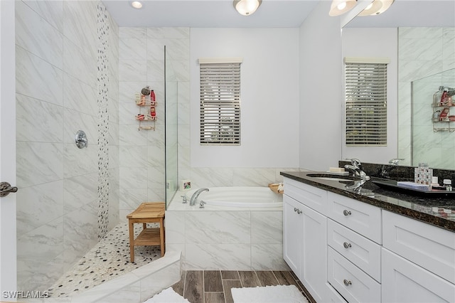 bathroom with vanity, a wealth of natural light, and separate shower and tub