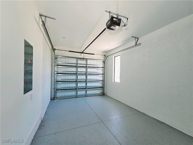 garage with a garage door opener and electric panel