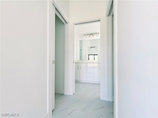 corridor featuring marble finish floor