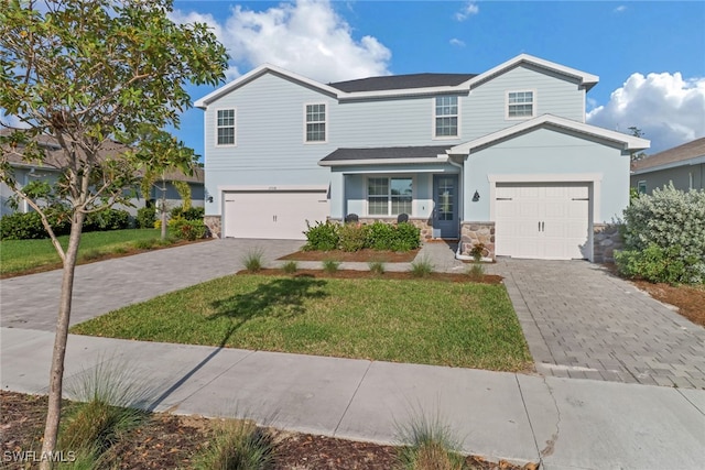 front facade with a garage and a front yard