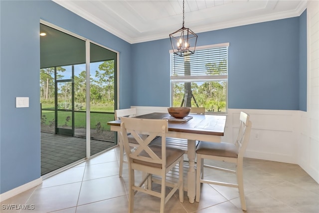 dining room with light tile patterned flooring, a notable chandelier, and ornamental molding