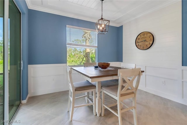 dining room with light tile patterned floors, crown molding, and an inviting chandelier