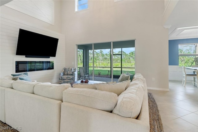 tiled living room featuring a towering ceiling