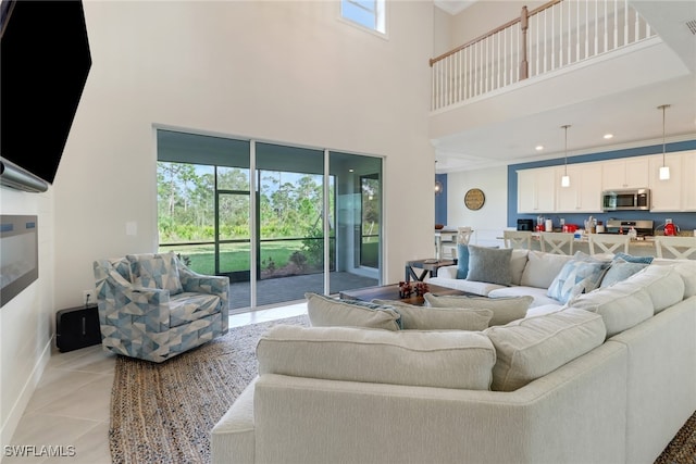 living room featuring light tile patterned floors and a high ceiling