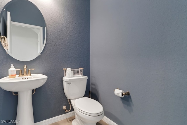 bathroom featuring sink and toilet