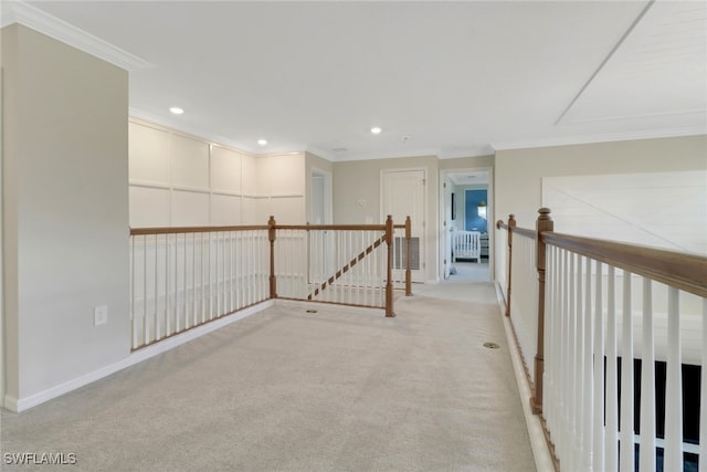 hallway featuring ornamental molding and light colored carpet