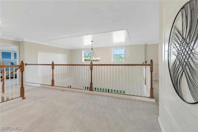 unfurnished room with crown molding, light colored carpet, and a notable chandelier