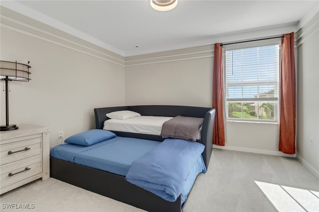 carpeted bedroom featuring ornamental molding