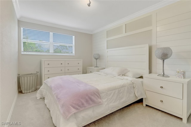 bedroom with ornamental molding and light carpet