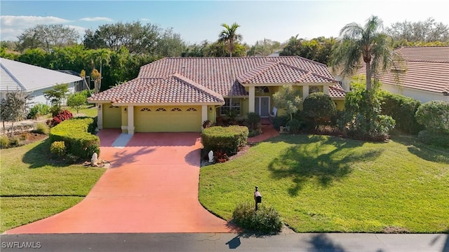 mediterranean / spanish-style house featuring a garage and a front yard