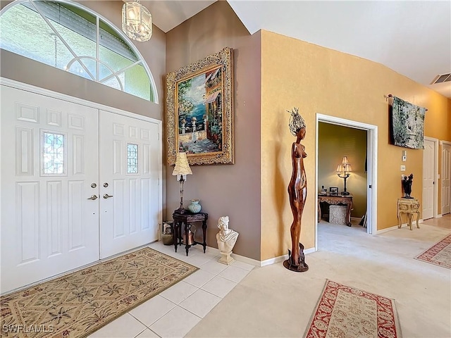 tiled foyer with a towering ceiling