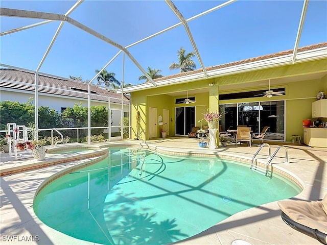 view of swimming pool with ceiling fan, a patio, and glass enclosure