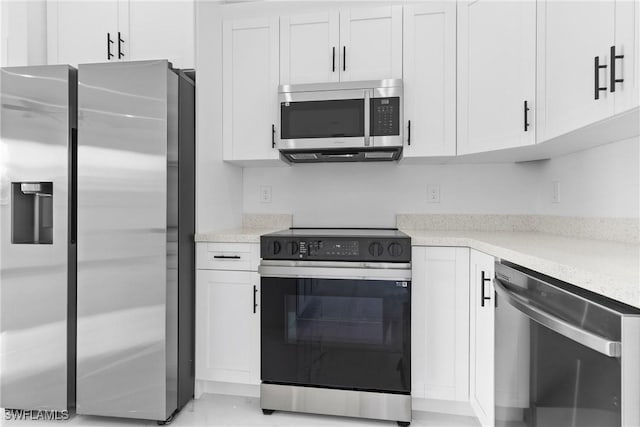 kitchen with white cabinets and appliances with stainless steel finishes