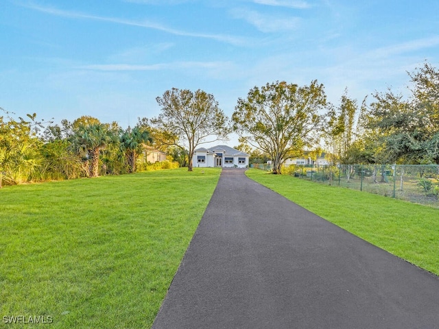 view of front of home featuring a yard and fence