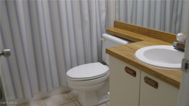 bathroom featuring sink, a shower with shower curtain, tile patterned floors, and toilet