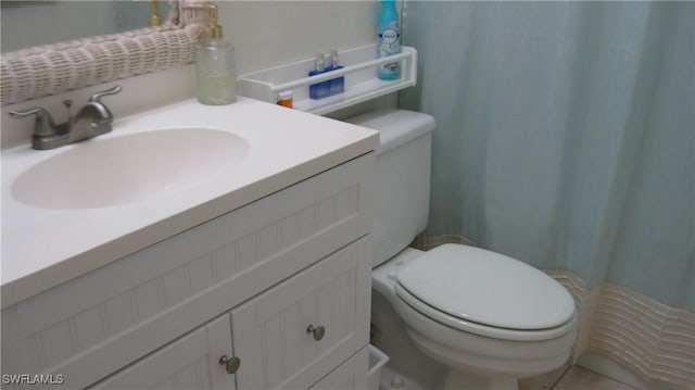 bathroom with vanity, curtained shower, and toilet