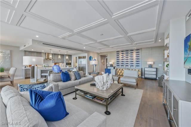 living room featuring coffered ceiling and hardwood / wood-style floors