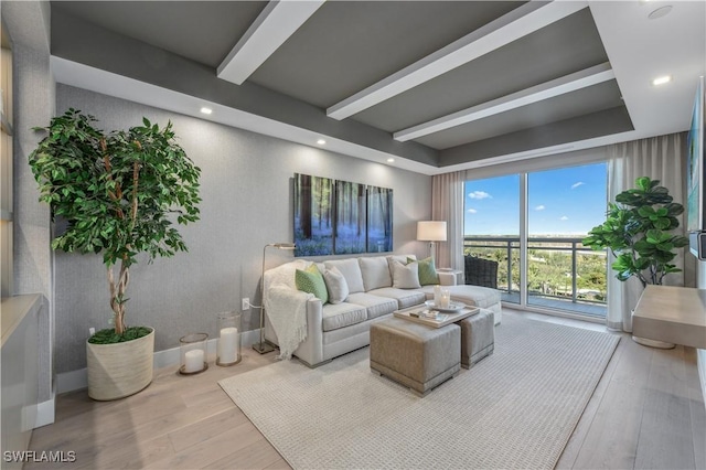 living room with beamed ceiling and light wood-type flooring