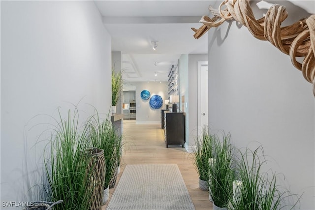 corridor with light hardwood / wood-style floors