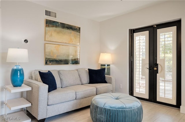 living room with light hardwood / wood-style floors and french doors