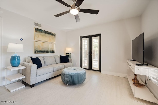 living room featuring french doors and ceiling fan