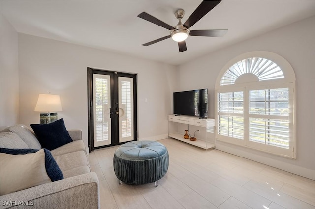 living room with french doors and ceiling fan