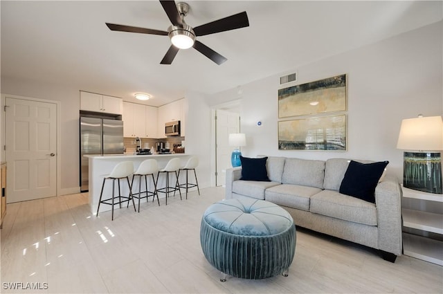 living room with ceiling fan