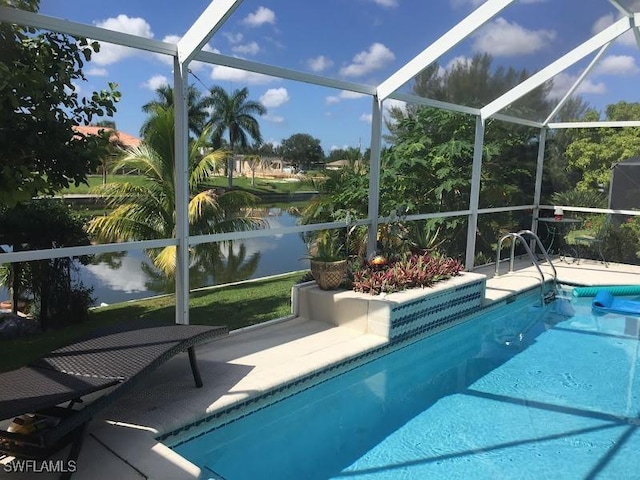 view of pool with a water view and glass enclosure