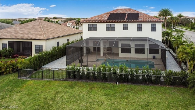 5222 N Ferrari Ave, Ave Maria, FL 34142 - rear view of house featuring a lawn, a lanai, a fenced in pool, a patio area, and solar panels