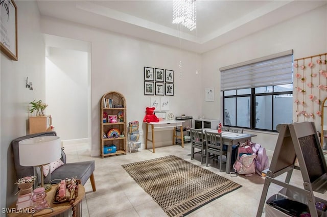 5222 N Ferrari Ave, Ave Maria, FL 34142 - interior space with a raised ceiling, light tile patterned flooring, and a notable chandelier