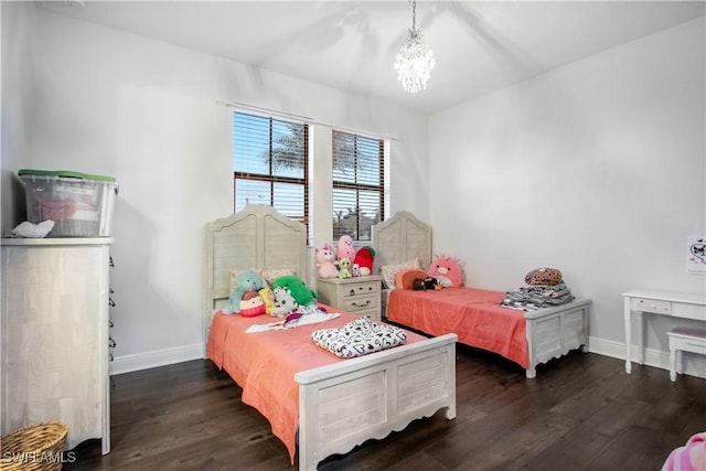 5222 N Ferrari Ave, Ave Maria, FL 34142 - bedroom featuring a notable chandelier and dark hardwood / wood-style flooring